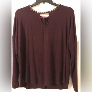 Lightweight sweater with cut-out and bead detail.